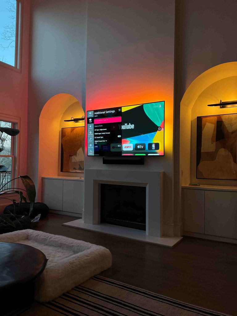 High fireplace TV installation with soundbar and clean setup
